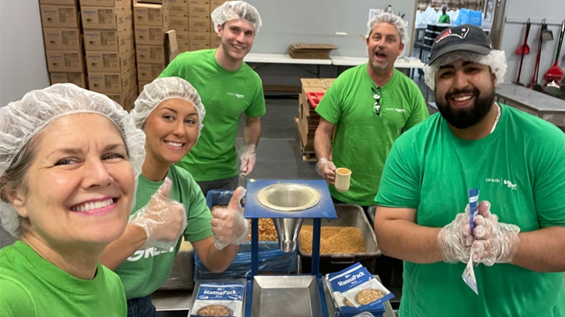 Four Habitat for Humanity volunteers working together